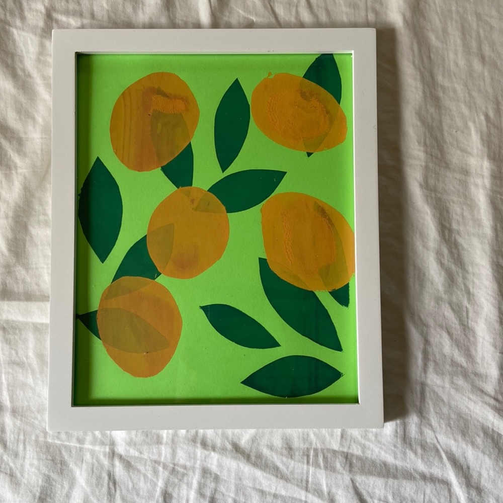 Oranges print with green leaves on green paper